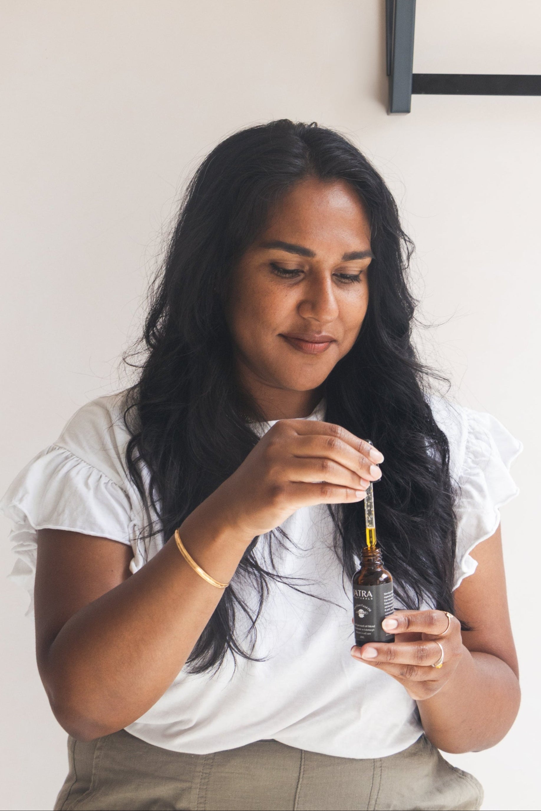 Holding Jatra Naturals Skin Glaze Facial Oil skincare 